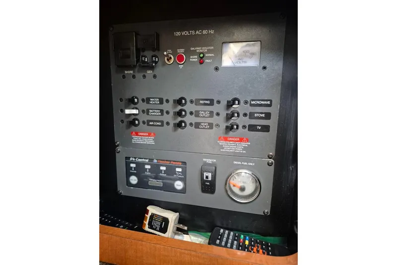 Slide: The Image of Electrical control panel on a 1987 Morgan 384 sailboat, featuring various switches and gauges. - 37