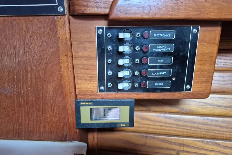 Slide: The Image of Control panel on a 1987 Morgan 384 sailboat with switches for electronics and instruments. - 39