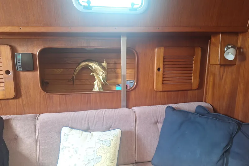 Slide: The Image of Interior of 1987 Morgan 384 yacht with wooden paneling and decorative dolphin sculpture. - 45