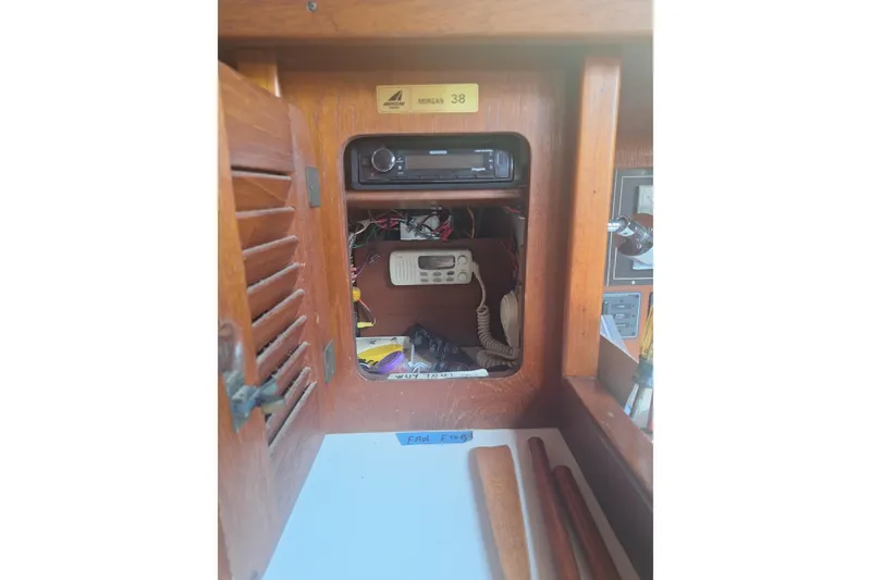Slide: The Image of 1987 Morgan 384 yacht interior with wooden paneling and communication equipment. - 49