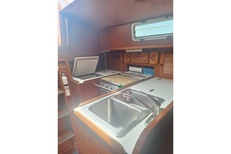 Slide: The Image of Interior of 1987 Morgan 384 sailboat galley with sink, stove, and storage. - 53