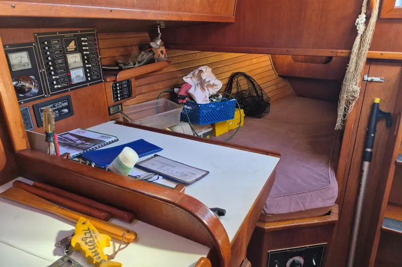 Slide: The Image of Interior of a 1987 Morgan 384 sailboat with navigation equipment and cozy berth. - 61