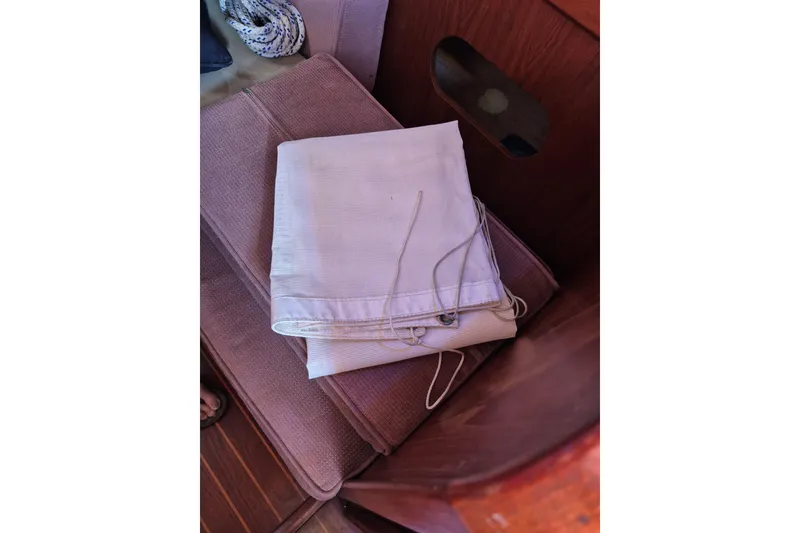 Slide: The Image of Folded sail on a Morgan 384 sailboat, 1987 model, resting on a cushioned seat. - 64