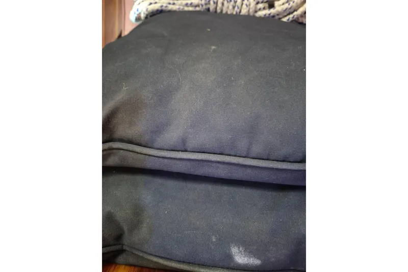 Slide: The Image of Black cushions on a Morgan 384 sailboat, 1987 model, with a rope in the background. - 65