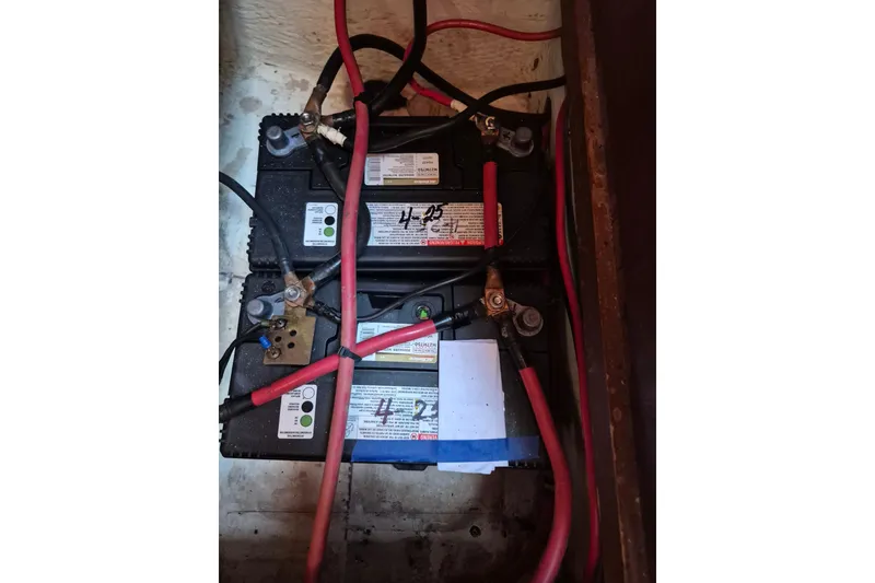 Slide: The Image of Battery setup in a 1987 Morgan 384 sailboat with connected cables. - 66