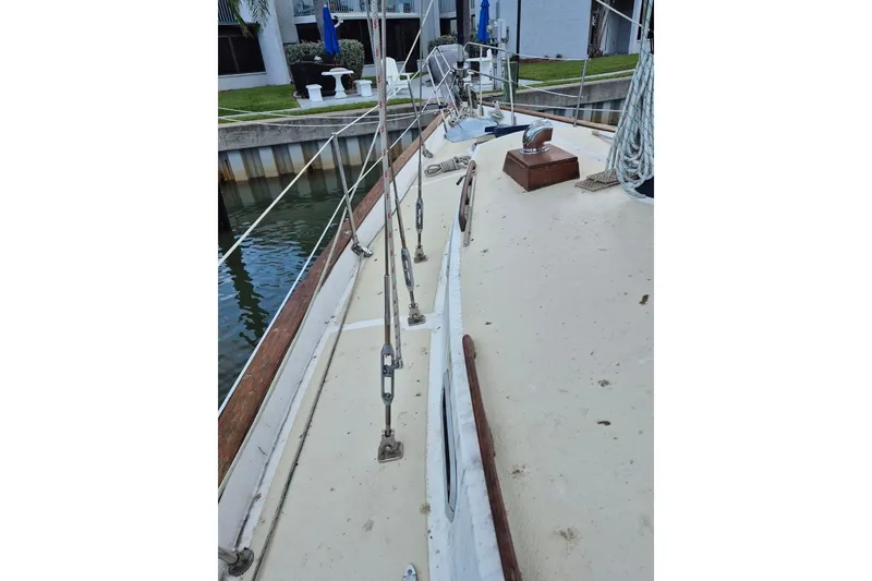 Slide: The Image of 1987 Morgan 384 sailboat deck with rigging and dockside view. - 7