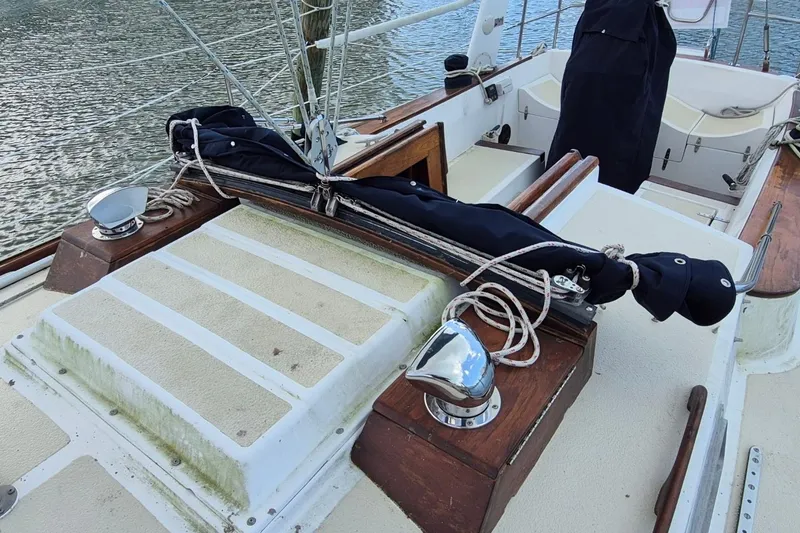 Slide: The Image of 1987 Morgan 384 sailboat deck with rigging and covered equipment. - 8