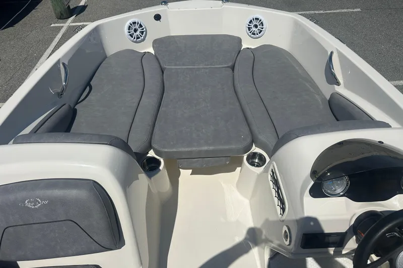 Slide: The Image of 2022 Stingray 182 SC boat interior with gray seating and dashboard. - 11