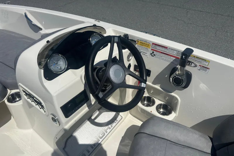 Slide: The Image of 2022 Stingray 182 SC boat dashboard with steering wheel and controls. - 12