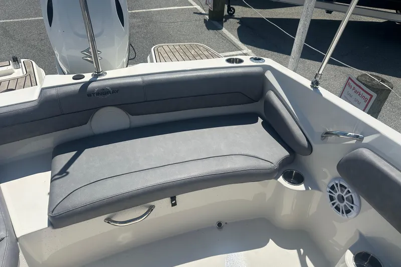 Slide: The Image of 2022 Stingray 182 SC boat interior with gray seating and cup holders. - 18