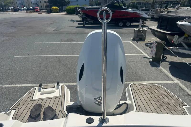 Slide: The Image of 2022 Stingray 182 SC boat with outboard motor in a parking lot. - 19