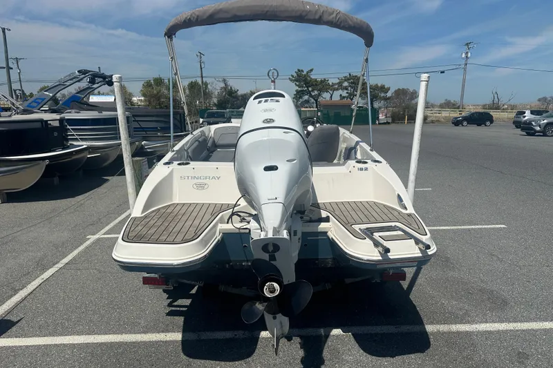 Slide: The Image of 2022 Stingray 182 SC boat in parking lot, rear view with outboard motor. - 7