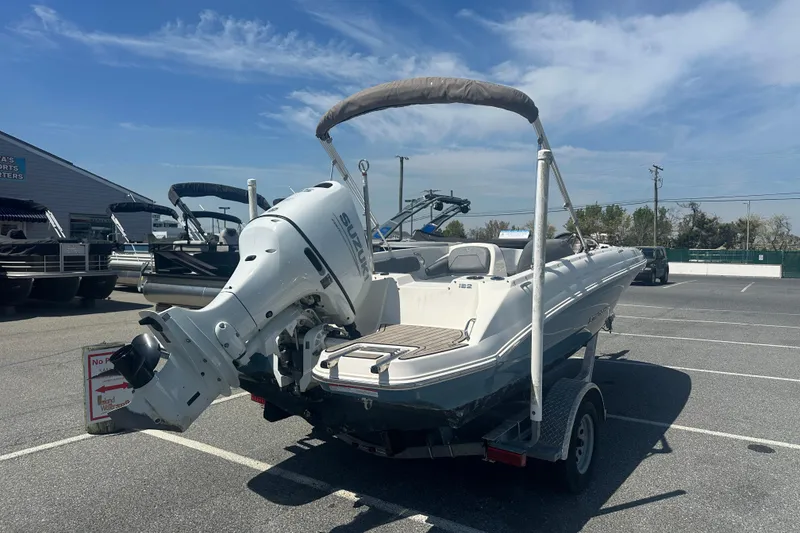 Slide: The Image of 2022 Stingray 182 SC boat with Suzuki outboard motor in a parking lot. - 8