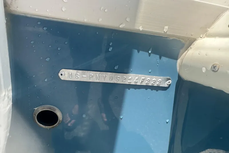 Slide: The Image of 2022 Stingray 182 SC boat hull identification number plate with water droplets. - 9