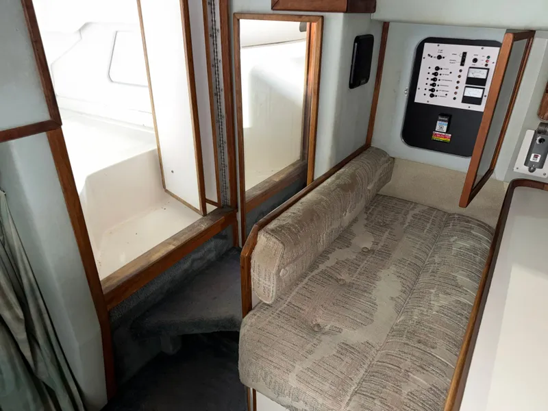 Slide: The Image of Interior of 1989 Sea Ray 300 Sundancer with seating and control panel. - 11
