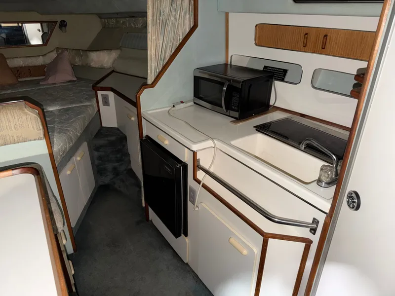 Slide: The Image of Interior of 1989 Sea Ray 300 Sundancer with kitchen and sleeping area. - 18
