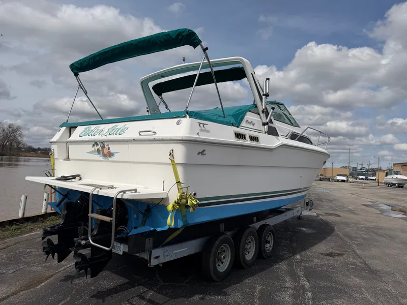 Slide: The Image of 1989 Sea Ray 300 Sundancer on trailer, cloudy sky. - 2