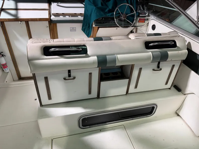 Slide: The Image of Interior of a 1989 Sea Ray 300 Sundancer with helm and seating area. - 22