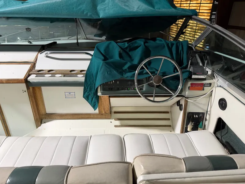 Slide: The Image of Interior of a 1989 Sea Ray 300 Sundancer boat with steering wheel. - 23