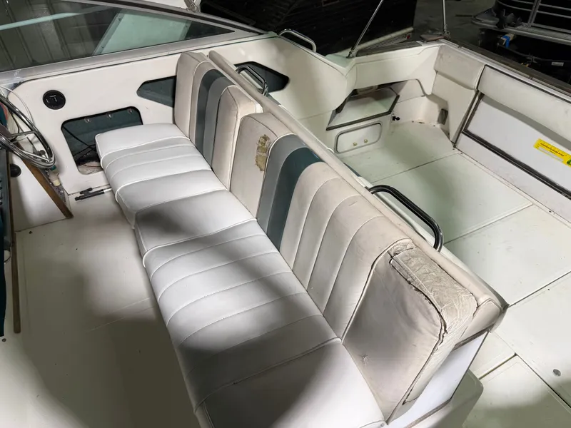 Slide: The Image of Interior of a 1989 Sea Ray 300 Sundancer boat with white seating. - 28