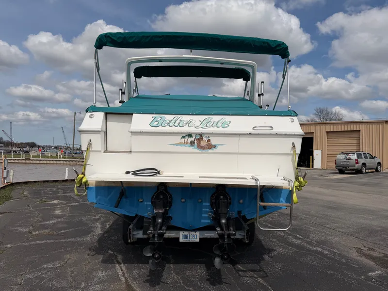 Slide: The Image of 1989 Sea Ray 300 Sundancer boat at dock with blue canopy. - 4