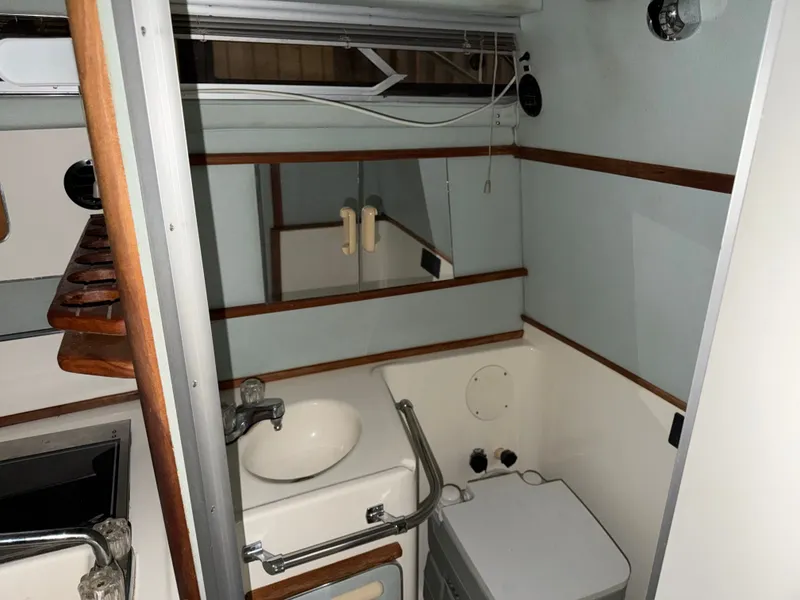 Slide: The Image of Interior of 1989 Sea Ray 300 Sundancer with sink and mirror. - 9