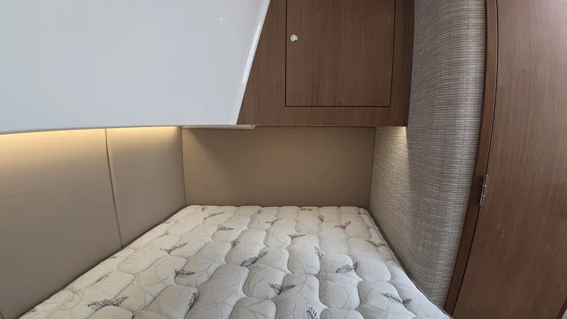 Slide: The Image of The cabin of the 2027 Intrepid 35 PANACEA features a cozy bed with padded walls. - 32