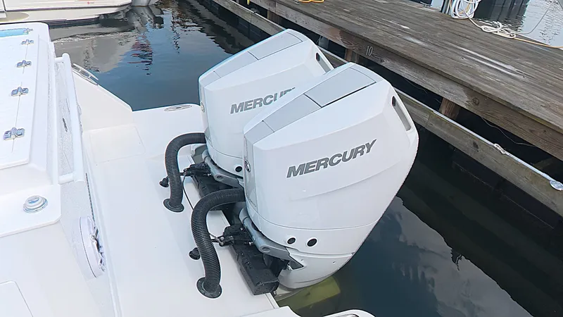 Slide: The Image of Two Mercury outboard engines on an Intrepid 35 PANACEA boat docked at a wooden pier. - 8