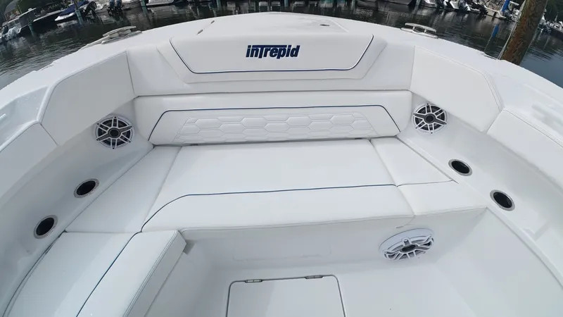 Slide: The Image of The image shows the seating area of an Intrepid 35 PANACEA boat with white upholstery. - 45