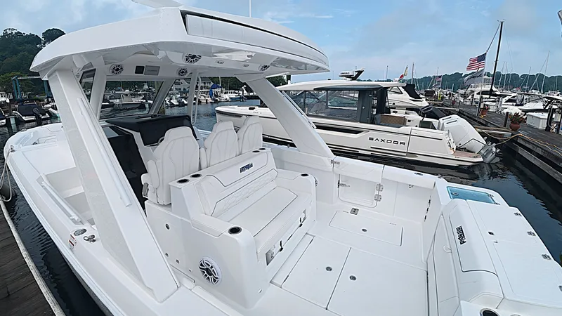 Slide: The Image of The image shows a modern Intrepid 35 PANACEA boat from 2027 with sleek white seating and a spacious deck, docked at a marina. - 6