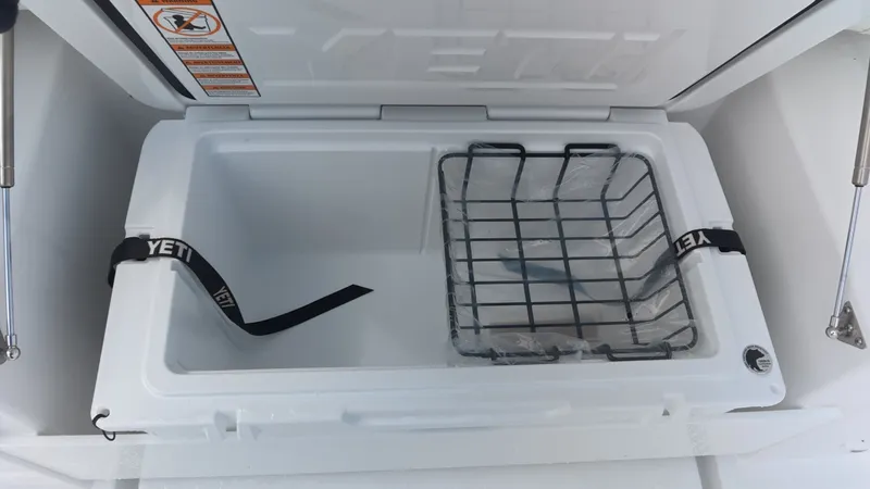 Slide: The Image of An open Yeti cooler with a metal basket inside, mounted on a boat. - 18