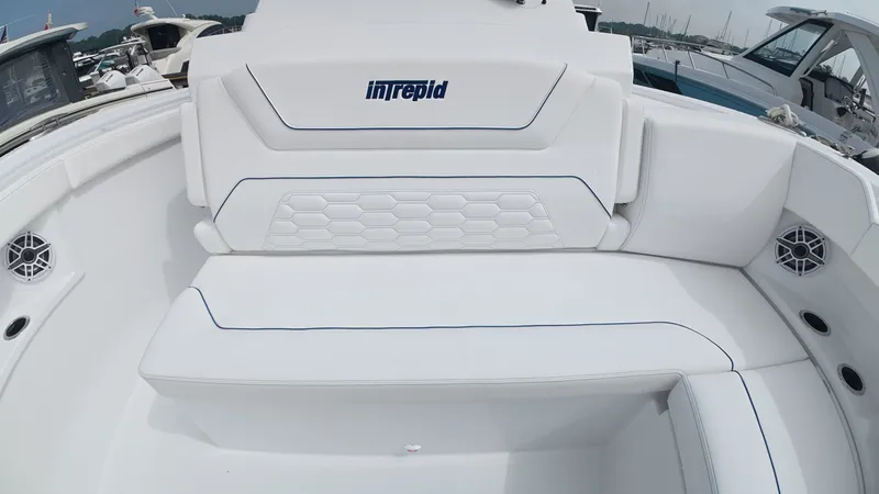 Slide: The Image of The 2027 Intrepid 35 PANACEA features luxurious white upholstery with blue accents in the seating area. - 43