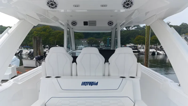 Slide: The Image of The image shows the cockpit of an Intrepid 35 PANACEA boat with white seats and speakers. - 19