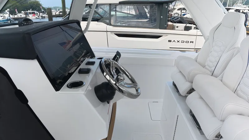 Slide: The Image of The cockpit of the 2027 Intrepid 35 PANACEA with a modern helm and comfortable seating. - 22