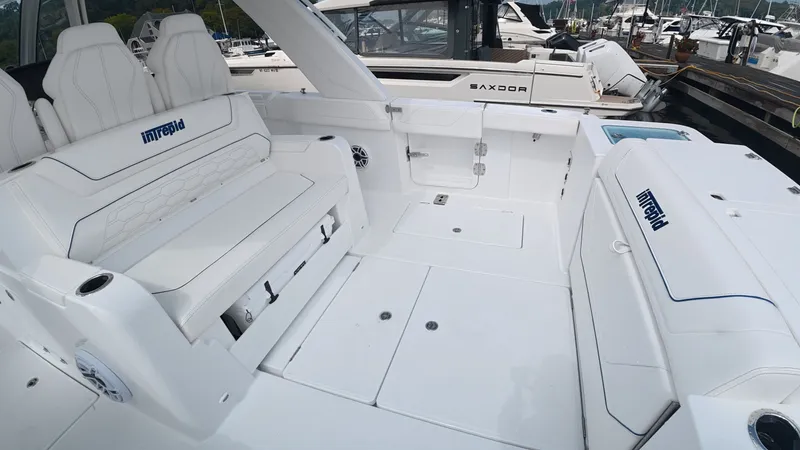 Slide: The Image of The image shows the cockpit of a 2027 Intrepid 35 PANACEA boat with white seating. - 13