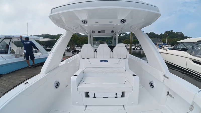 Slide: The Image of The image shows a modern Intrepid 35 PANACEA boat with white seating and a spacious deck. - 14