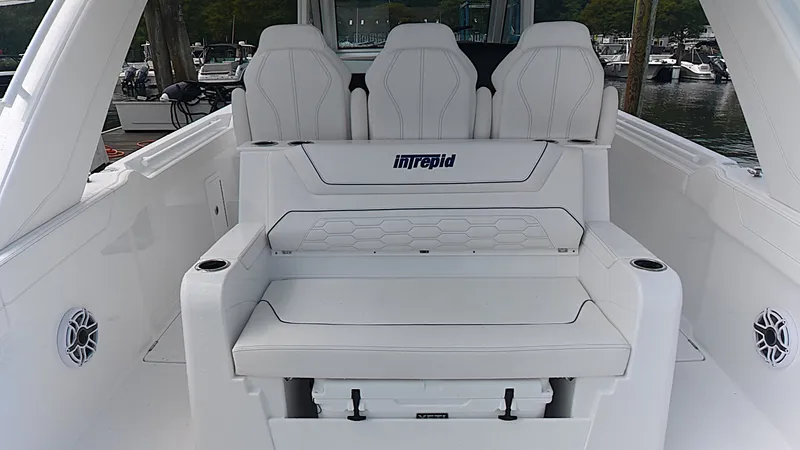 Slide: The Image of The 2027 Intrepid 35 PANACEA features a luxurious white bench seat with integrated storage. - 15