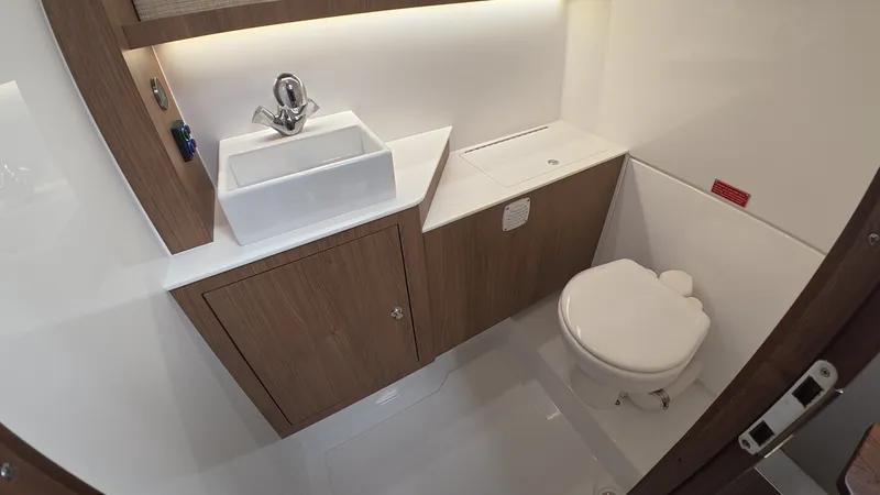 Slide: The Image of The image shows a modern boat bathroom with a sink and toilet. - 35