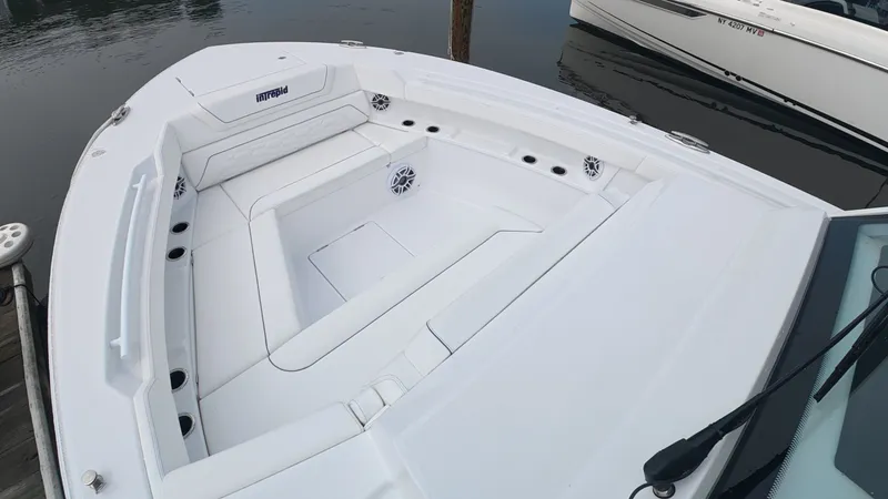 Slide: The Image of The image shows the bow area of a 2027 Intrepid 35 PANACEA boat with white upholstery. - 39