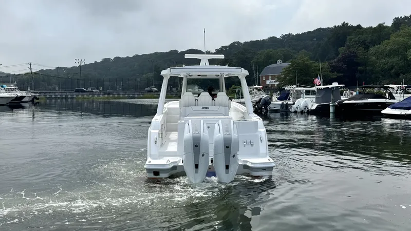 Slide: The Image of A 2027 Intrepid 35 PANACEA on calm water, featuring three outboard engines. - 4