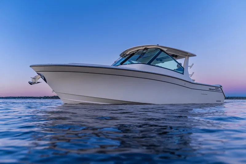 Slide: The Image of 2027 Grady-White Freedom 345 on calm water at sunset. - 3