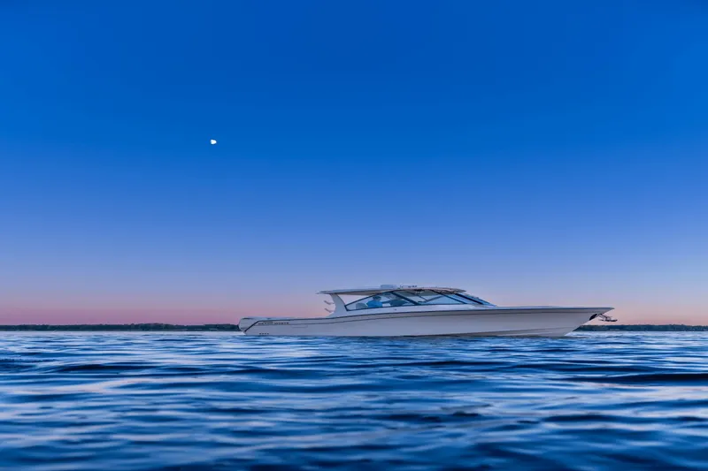 Slide: The Image of Grady-White Freedom 345 from 2027 on calm waters at sunset. - 2
