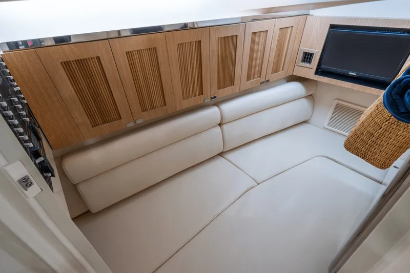 Slide: The Image of Interior of the Grady-White Freedom 345 featuring sleek wooden cabinetry and a built-in TV. - 9