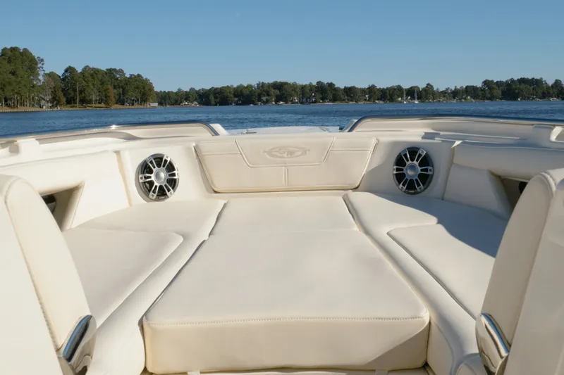 Slide: The Image of The image shows the spacious bow area of a Grady-White Freedom 345, surrounded by water and trees. - 8