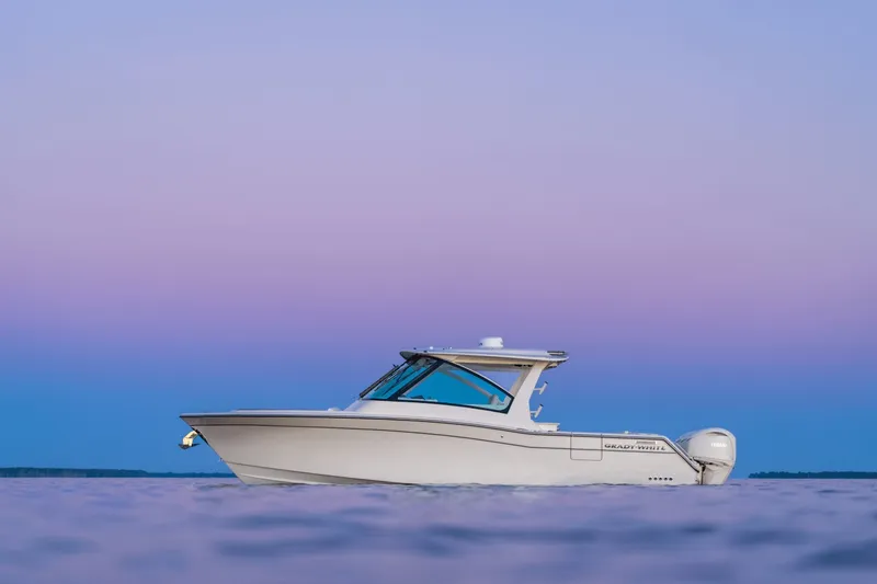 Slide: The Image of Grady-White Freedom 345 from 2027 on calm water at sunset. - 4