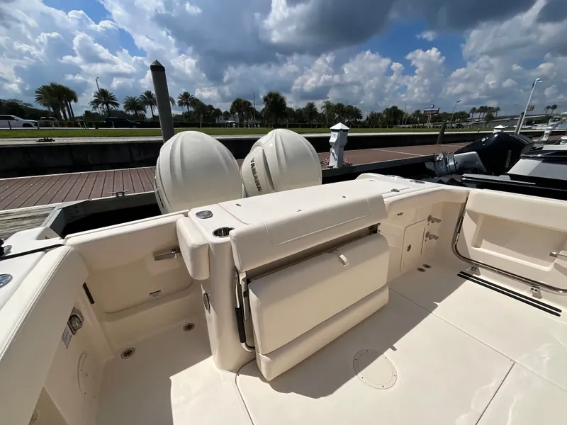 Slide: The Image of The image shows the cockpit of a Grady-White Canyon 306 boat with dual engines. - 2