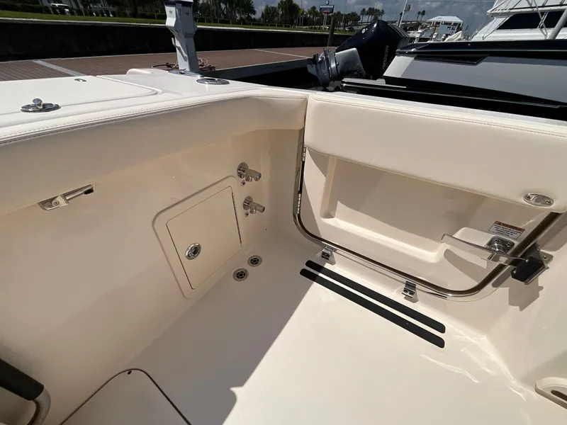 Slide: The Image of The image shows the cockpit of a 2027 Grady-White Canyon 306 with storage and grab rails. - 3