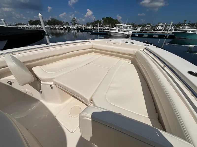 Slide: The Image of The image shows the bow seating area of a Grady-White Canyon 306 boat in a marina. - 14
