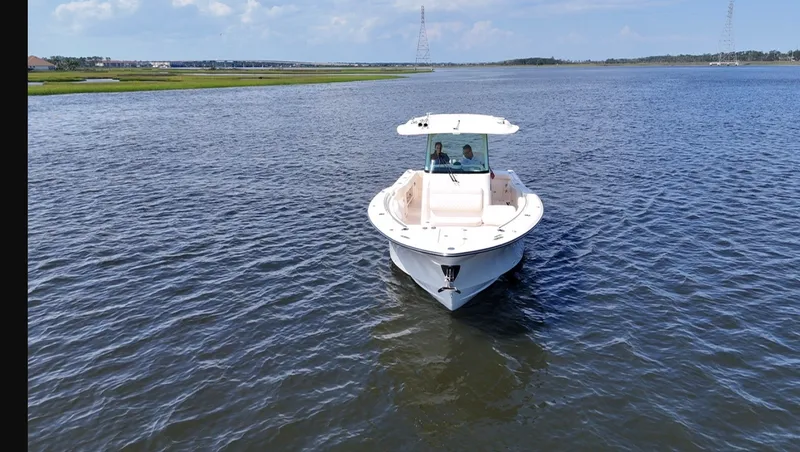 Slide: The Image of 2027 Grady-White Canyon 306 on calm water with two people on board. - 28