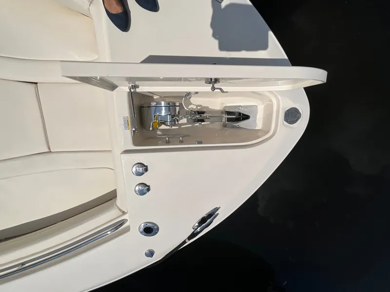 Slide: The Image of The image shows the deck of a Grady-White Canyon 306 boat with an anchor locker. - 17